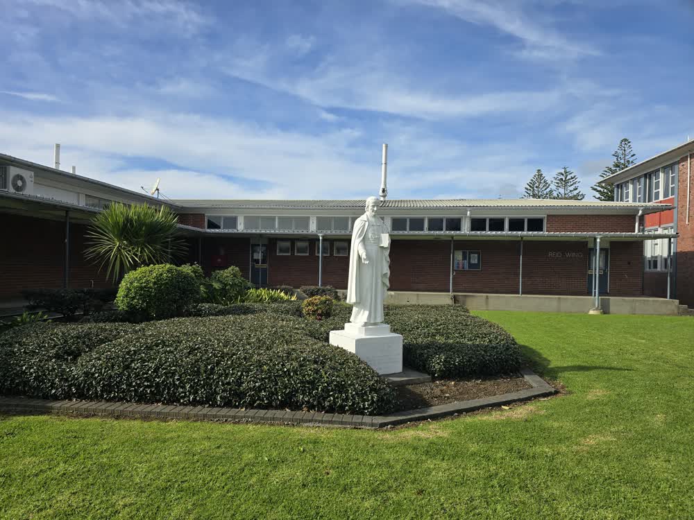 Star Jasmine and statue in garden bed at Sacred Heart College